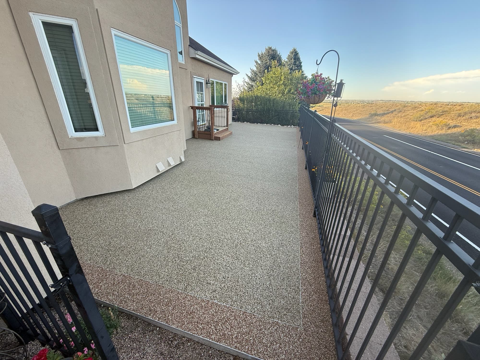 Resurfaced side patio in a light Vuba Stone blend with a darker contrasting border